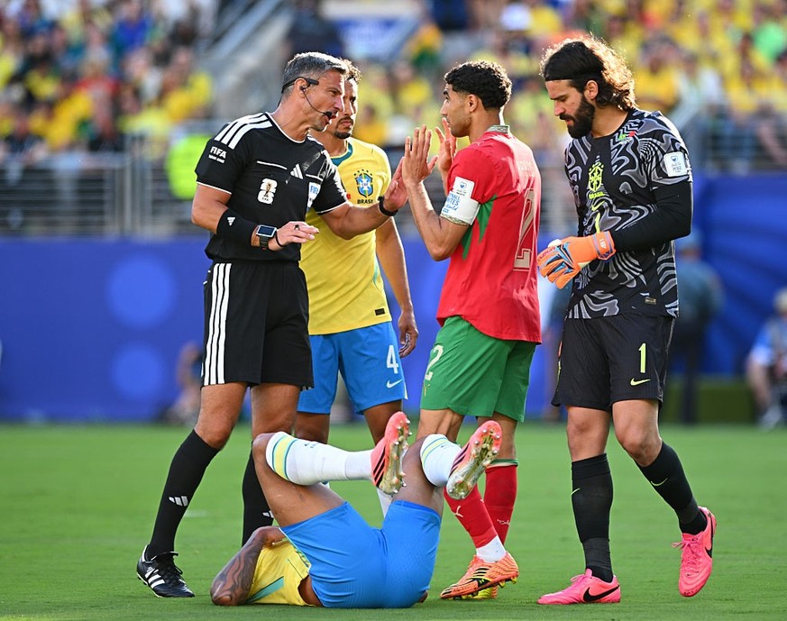 EAST RUTHERFORD, NEW JERSEY - JUNE 13: Referee Slavko Vincic talks to Achraf Hakimi of Morocco during the FIFA World Cup 2026 Group C match between Brazil and Morocco at New York New Jersey Stadium on ...