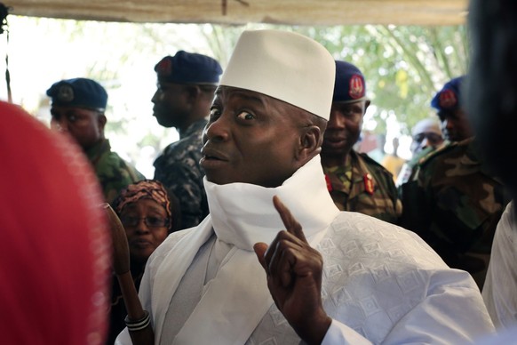 FILE - Former Gambian president Yahya Jammeh shows his inked marked finger moments before voting in Banjul, Gambia, Dec. 1, 2016. Gambians vote Saturday Dec. 3, 2021 in a historic election that will f ...
