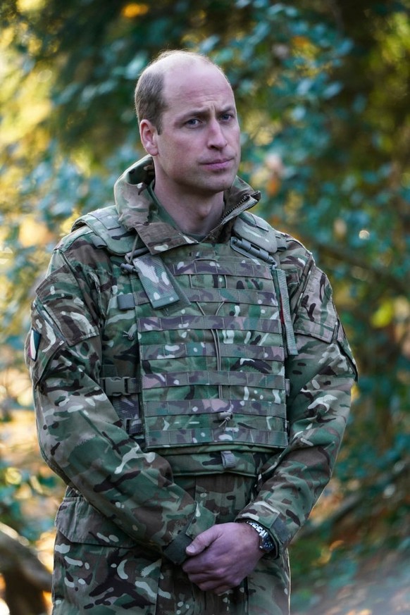 SALISBURY, ENGLAND - NOVEMBER 23: Prince William, Prince of Wales, Colonel-in-Chief, 1st Battalion Mercian Regiment (L) listens to a briefing ahead of an attack exercise during a visit to the regiment ...