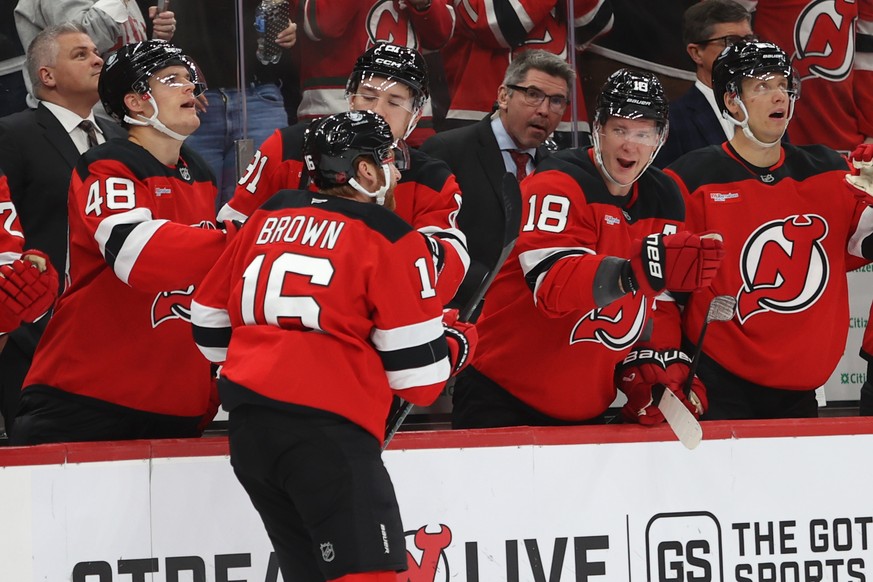New Jersey Devils&#039; Connor Brown reacts with teammates after scoring during the second period of an NHL hockey game against the Colorado Avalanche, Sunday, Oct. 26, 2025, in Newark, N.J. (AP Photo ...