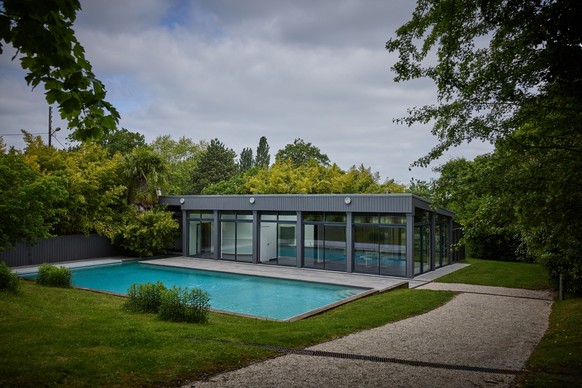 (FILES) This photograph shows the swimming pool and poolhouse at a former residence of the late German fashion designer Karl Lagerfeld, in Louveciennes, near Paris, on May 15, 2025. The historic 19th  ...