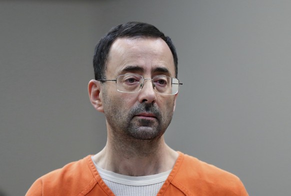 FILE - Disgraced former sports doctor Larry Nassar appears in court for a plea hearing, Nov. 22, 2017, in Lansing, Mich. (AP Photo/Paul Sancya, File)
Larry Nassar