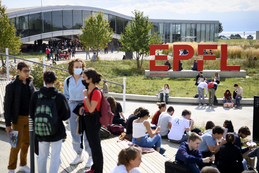 Students take a lunch break outside the Learning Center the first day of university schools at the Swiss Federal Institute of Technology (EPFL) during the coronavirus disease (COVID-19) outbreak, in L ...