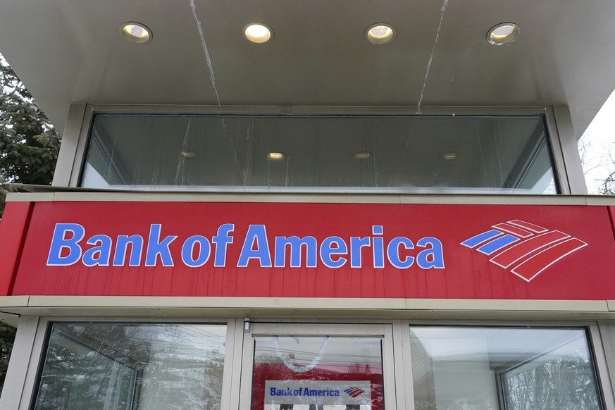 A Bank of America ATM is seen, Wednesday, Feb. 3, 2021, in Winchester, Mass. Bank of America is slashing the amount it charges customers when they spend more than they have in their accounts and plans ...