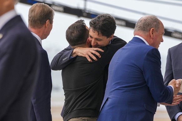 Canadian Prime Minister Justin Trudeau, right, hugs Ukrainian President Volodymyr Zelenskyy prior to an international ceremony to mark the 80th anniversary of D-Day at Omaha Beach in Saint-Laurent-sur ...