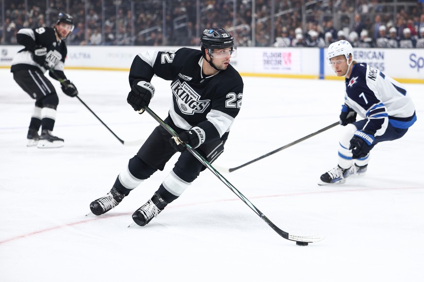 Los Angeles Kings left wing Kevin Fiala (22) skates with the puck as right wing Adrian Kempe, back left, and Winnipeg Jets center Vladislav Namestnikov (7) watch during the second period of an NHL hoc ...