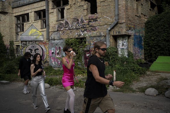 People make on their way to a daytime party in Kyiv, Ukraine, Saturday, Aug. 26, 2023. (AP Photo/Bram Janssen)