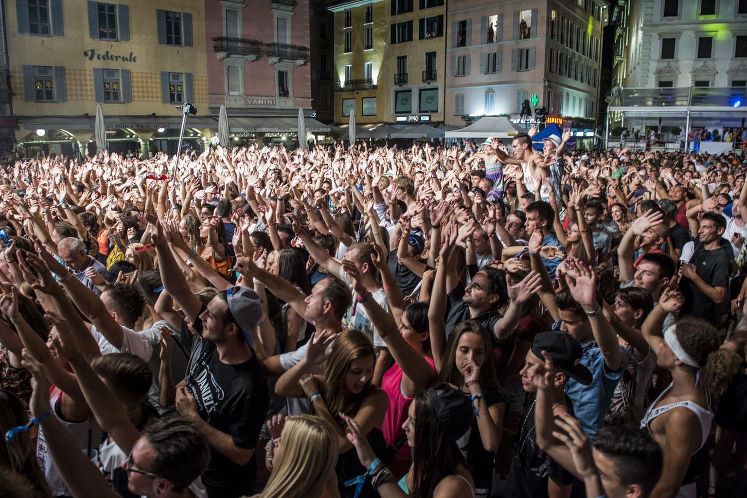 Die tanzende Menge auf der Piazza Riforma aufgenommen waehrend dem Konzert von DJ Pat Farrell am City Beats Festival in Lugano in den fruehen Morgenstunden vom Sonntag, 26. Juli 2015. (KEYSTONE/Pablo  ...