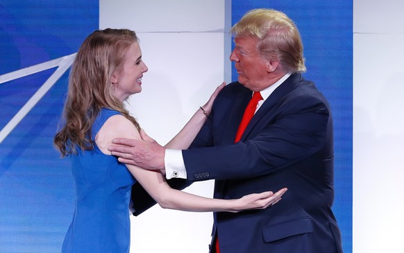 President Donald Trump, right, greets Natalie Harp, left, and invites her to speaks at the Faith &amp; Freedom Coalition conference in Washington, Wednesday, June 26, 2019. (AP Photo/Pablo Martinez Mo ...