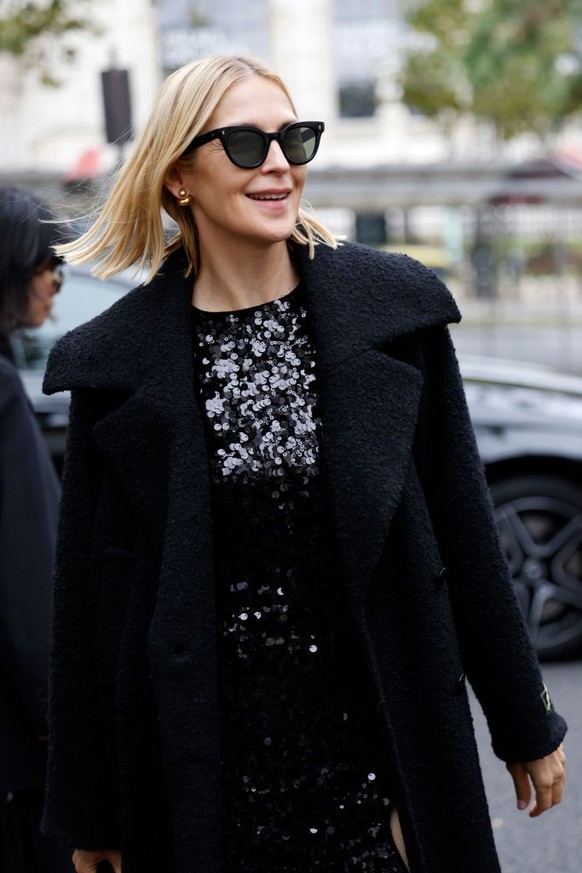 BERLIN, GERMANY - DECEMBER 10: Sonia Lyson is seen wearing black, oval-shaped Vehla sunglasses. Her outfit is cream-colored, consisting of a long, oversized faux fur coat that reaches her ankles. Unde ...