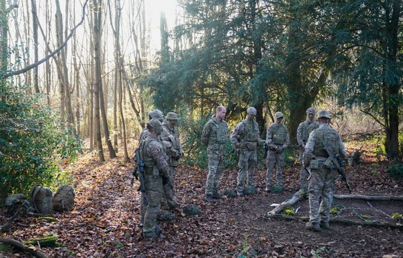 SALISBURY, ENGLAND - NOVEMBER 23: Prince William, Prince of Wales, Colonel-in-Chief, 1st Battalion Mercian Regiment (L) listens to a briefing ahead of an attack exercise during a visit to the regiment ...