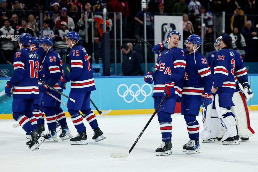 epa12756068 Players of USA celebrate winning the Men's Ice Hockey quarterfinal match between USA and Sweden at the Milano Cortina 2026 Winter Olympic Games in Milano, Italy, 18 February 2026. EPA ...