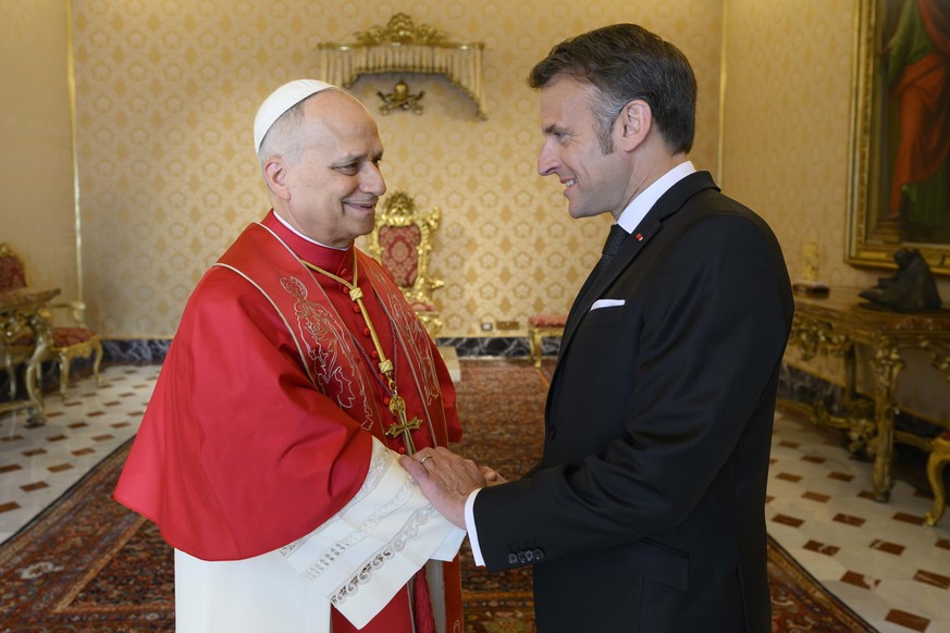 epa12880005 A handout picture provided by the Vatican Media shows Pope Leo XIV (L) and French President Emmanuel Macron during a private audience in Vatican City, 10 April 2026. EPA/VATICAN MEDIA HAND ...