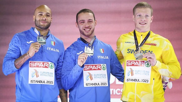 epa10504251 (L-R) Silver medalist Lamont Marcell Jacobs, gold medalist Samuele Ceccarelli, both of Italy and bronze medalist Henrik Larsson of Sweden celebrate on the podium for the 60m Men&#039;s Fin ...