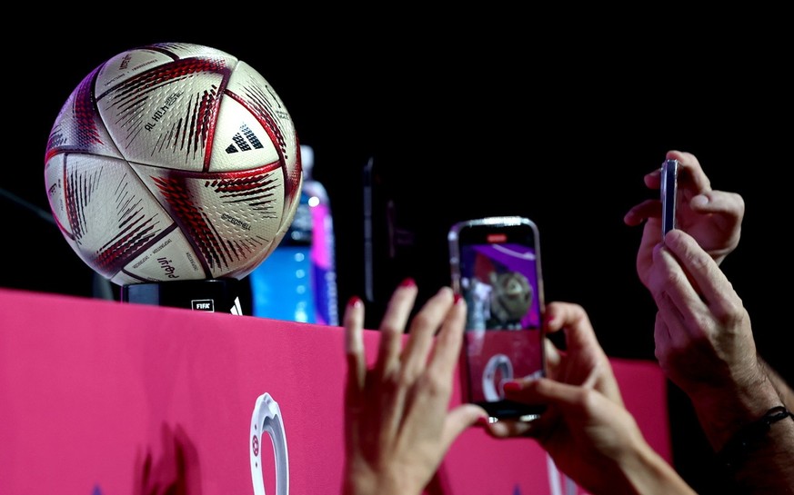 epa10361872 Journalists take pictures of the matchball for the semi finals and final, Al Hilm (The Dream) before the start of the press conferences of Argentina and Croatia at the Qatar National Conve ...