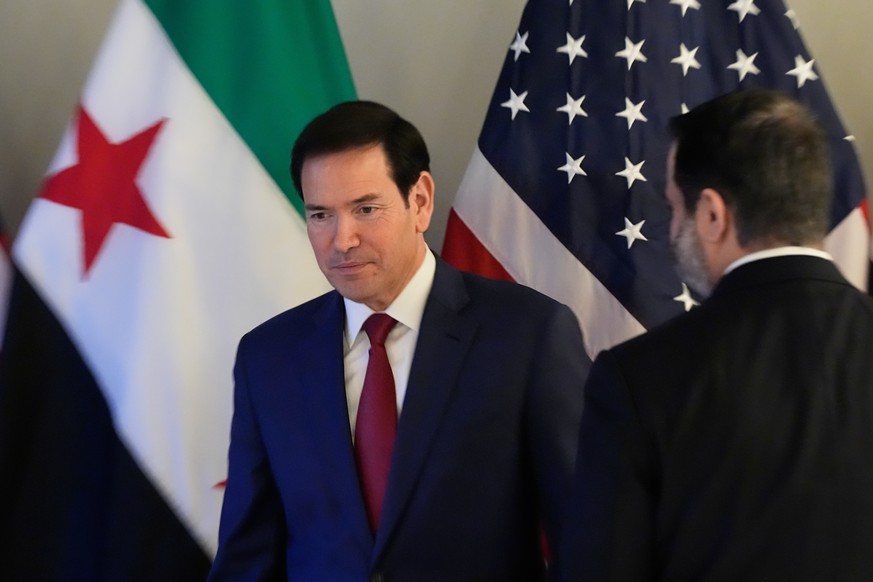U.S. Secretary of State Marco Rubio, left, and Syrian Foreign Minister Asaad al-Shibani meet in Munich, Germany, Friday, Feb. 13, 2026, on the sidelines of the Munich Security Conference. (AP Photo/Al ...