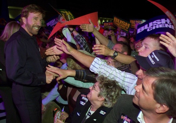 (FILES) Actor Chuck Norris(L) currently the star of the US television show "Walker, Texas Ranger" works the crowd to campaign for US Republican Presidential candidate Texas Governor George W ...