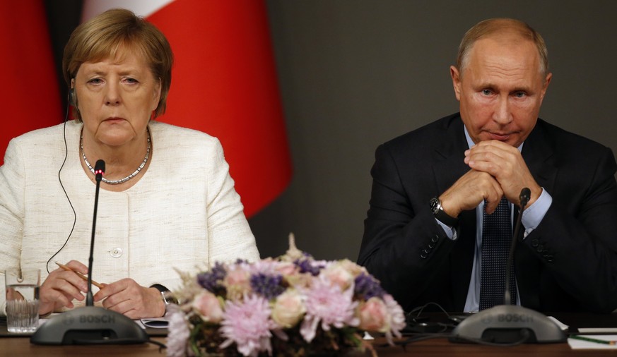 FILE - In this Saturday, Oct. 27, 2018 file photo, German Chancellor Angela Merkel, left, and Russian President Vladimir Putin attend a news conference following a summit on Syria, in Istanbul. Merkel ...