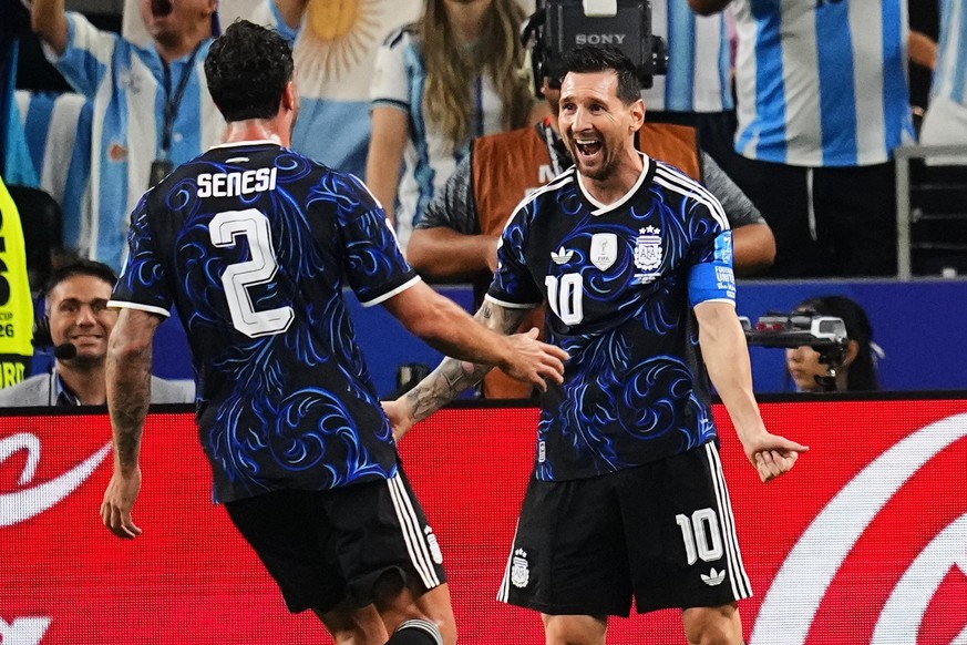 Argentina's Lionel Messi, right, celebrates with Leandro Paredes after scoring his side's third goal on a free kick during the World Cup Group J soccer match against Jordan in Arlington, Tex ...