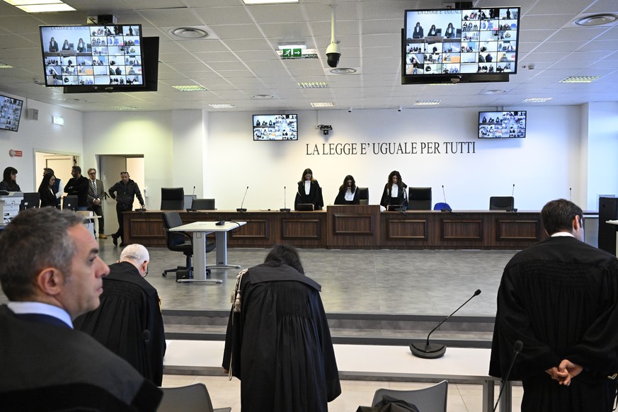 Facing the camera, President of the court Judge Brigida Cavasino, center, flanked by judges Claudia Caputo, left, and Germana Radice reads the sentence of a maxi-trial of hundreds of people accused of ...