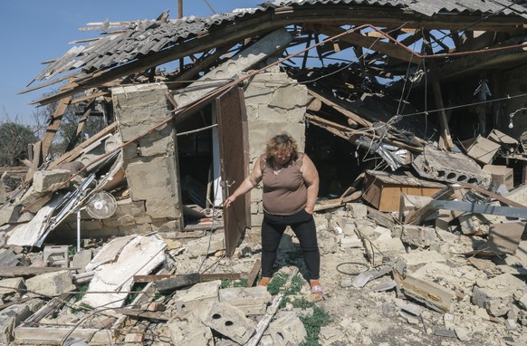 epa11551412 Local Ukrainian woman Natalia inspects the destroyed home of an aquaintance in a village not far from the Ukraine - Russian border in the Kursk direction of the Sumy region, Ukraine, 16 Au ...
