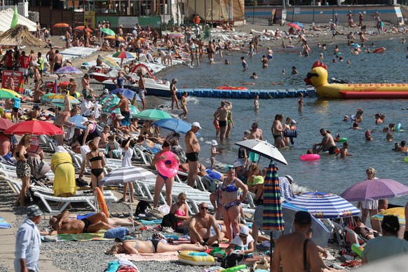 epa10778089 People enjoy a day at a beach of the Black Sea in Alushta, Crimea, 24 July 2023 (issued 31 July 2023). Crimea was annexed by Russia in 2014, shortly after Crimeans voted in a disputed refe ...