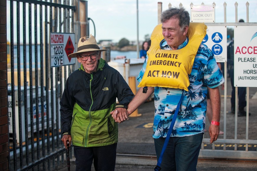 NEWCASTLE, AUSTRALIA - NOVEMBER 26: 97 year old Reverend Alan Stuart (L) walks out the Port Authority of NSW after being arrested by police among the other protestors as they continue to blockade the  ...