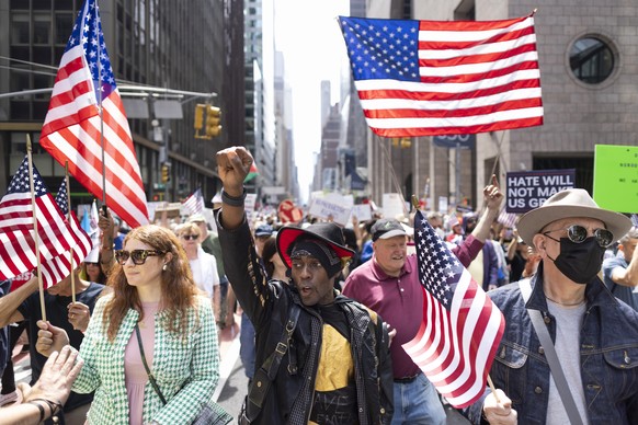 epa12041452 People participate in a rally and march as part of a national day of protest again the policies of the Trump administration in New York, New York, USA, 19 April 2025. EPA/JUSTIN LANE