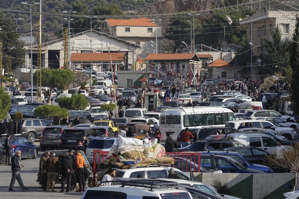 Cars are backed up at the Masnaa border crossing point in the Bekaa Valley, Lebanon, as people attempt to cross into Syria on Sunday, Dec. 8, 2024. (AP Photo/Hassan Ammar)