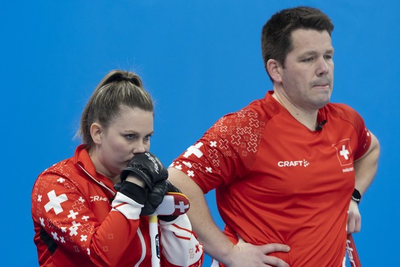 Jenny Perret, left, and Martin Rios of Switzerland team during curling mixed doubles preliminary round game between Sweden and Switzerland at the 2022 Olympic Winter Games in Beijing, China, on Saturd ...
