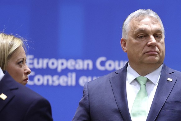 Hungary&#039;s Prime Minister Viktor Orban, right, and Italy&#039;s Prime Minister Giorgia Meloni attend a round table meeting at an EU summit in Brussels, Thursday, March 23, 2023. European Union lea ...
