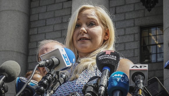 FILE - Virginia Roberts Giuffre holds a news conference outside a Manhattan court following the jailhouse death of Jeffrey Epstein, Aug. 27, 2019, in New York. A tentative settlement has been reached  ...