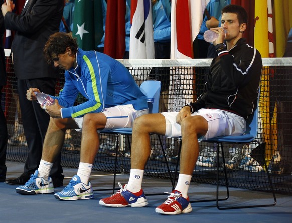 Novak Djokovic of Serbia, right, and Rafael Nadal of Spain take a drink before the awarding ceremony, after Djokovic won over Nadal in the men&#039;s singles final at the Australian Open tennis champi ...