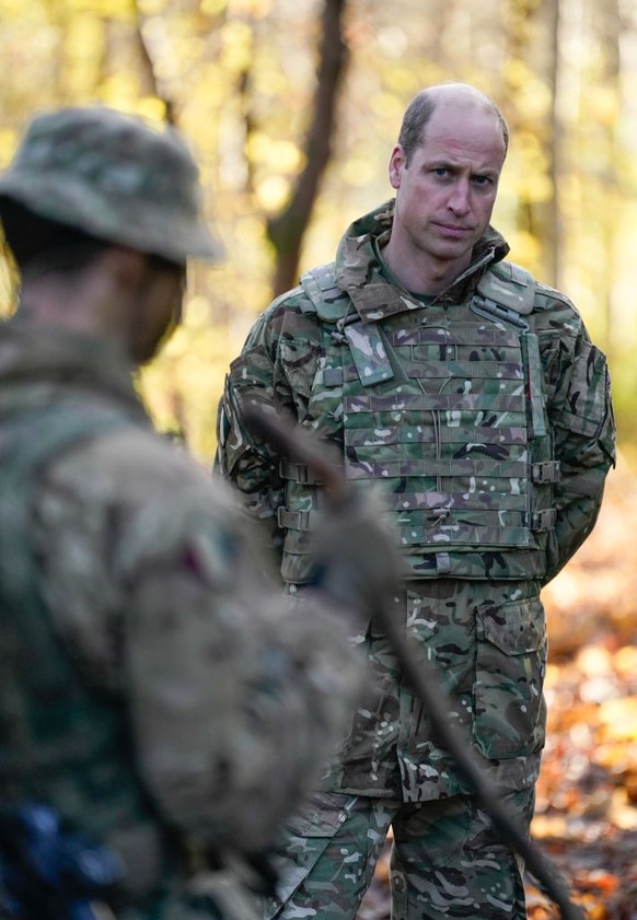 SALISBURY, ENGLAND - NOVEMBER 23: Prince William, Prince of Wales, Colonel-in-Chief, 1st Battalion Mercian Regiment (L) listens to a briefing ahead of an attack exercise during a visit to the regiment ...