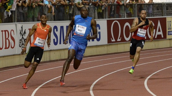 Usain Bolt from Jamaica, center, with Warren Weir, from Jamaica, left, and Wallace Spearman, from the USA, compete in the mens 200m race, at the Athletissima IAAF Diamond League athletics meeting in t ...