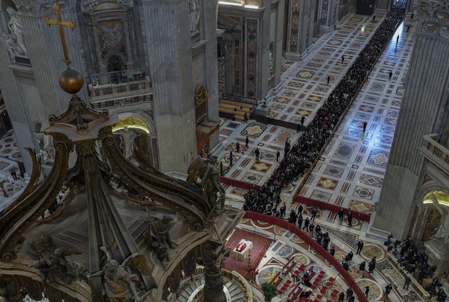 In this image released on Monday, Jan. 2, 2023, by the Vatican Media news service, the body of late Pope Emeritus Benedict XVI is lied out in state inside St. Peter's Basilica at The Vatican wher ...