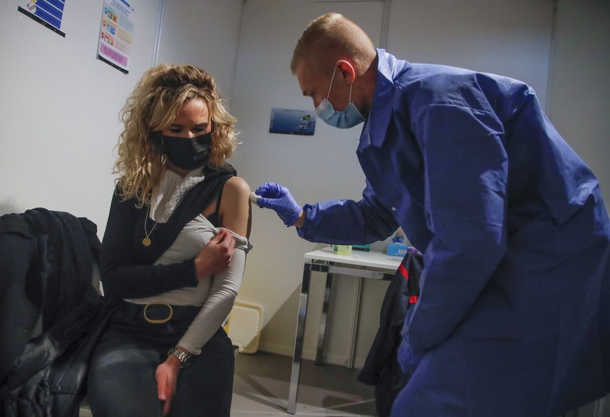 A woman receives a Pfizer COVID-19 vaccine at a new vaccination center run by the Paris&#039; fire brigade in Paris, Thursday, May 6, 2021. France joined the United States on Thursday in supporting an ...