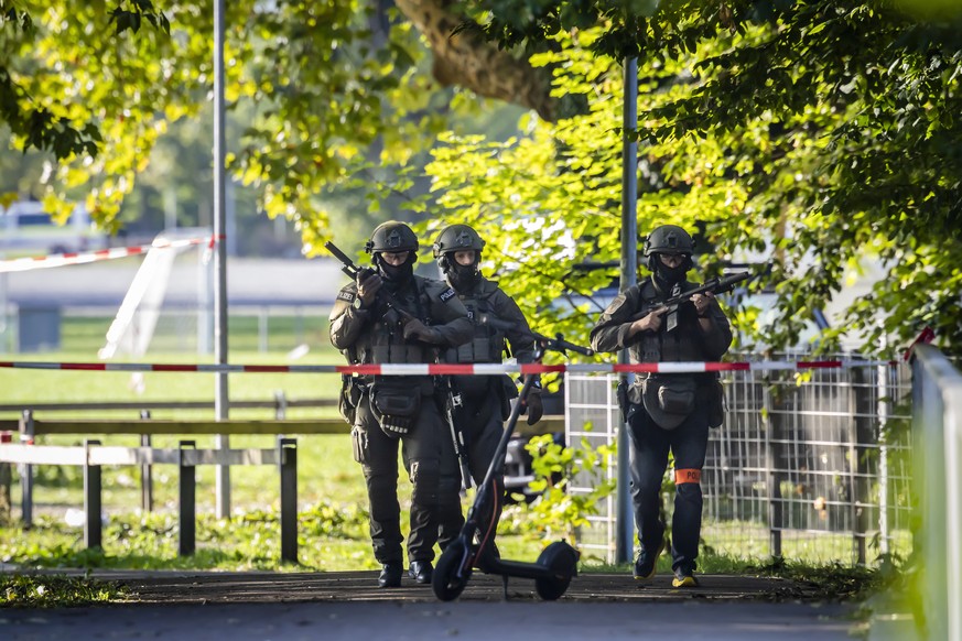 Armed police officers patrol near the Schachen horse racing track in Aarau following a shooting during a rave event at the Schachen horse racing track near Aarau, Switzerland on Sunday, August 30, 202 ...