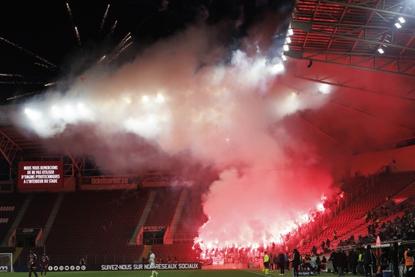 Sion&#039;s supporters light smoke flares and fireworks, during the Super League soccer match of Swiss Championship between Servette FC and FC Sion, at the Stade de Geneve stadium, in Geneva, Switzerl ...