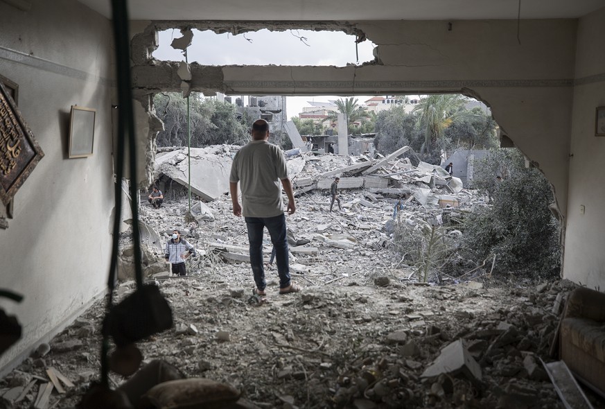 epaselect epa10624527 A Palestinian man stands in a damaged room of a destroyed house following an Israeli air strike in the Deir Al-Balah town in the central Gaza Strip, 13 May 2023. Israel carried o ...