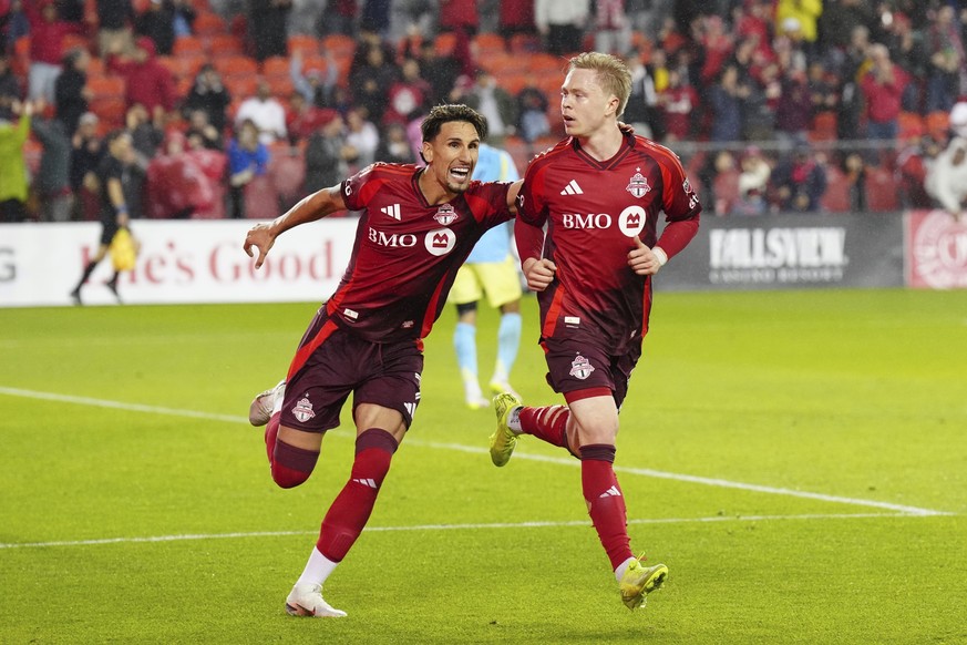 Toronto FC&#039;s Ola Brynhildsen, right, celebrates with Theo Corbeanu after scoring against the Philadelphia Union during the second half of a MLS soccer match in Toronto, Wednesday, May 28, 2025. ( ...