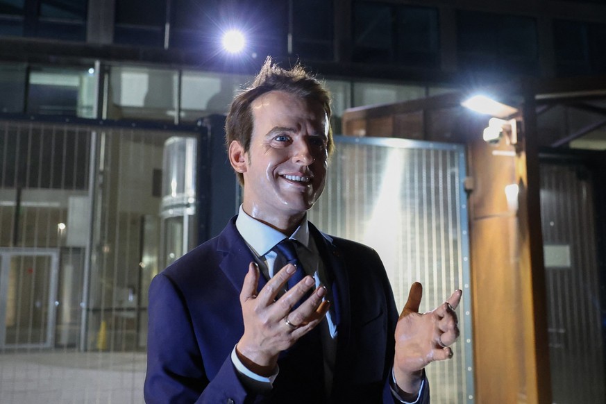 A photo shows a wax statue of French President Emmanuel Macron, stolen the day before from the Grevin Museum, during an action by Greenpeace environmental activists outside the EDF headquarters in Par ...