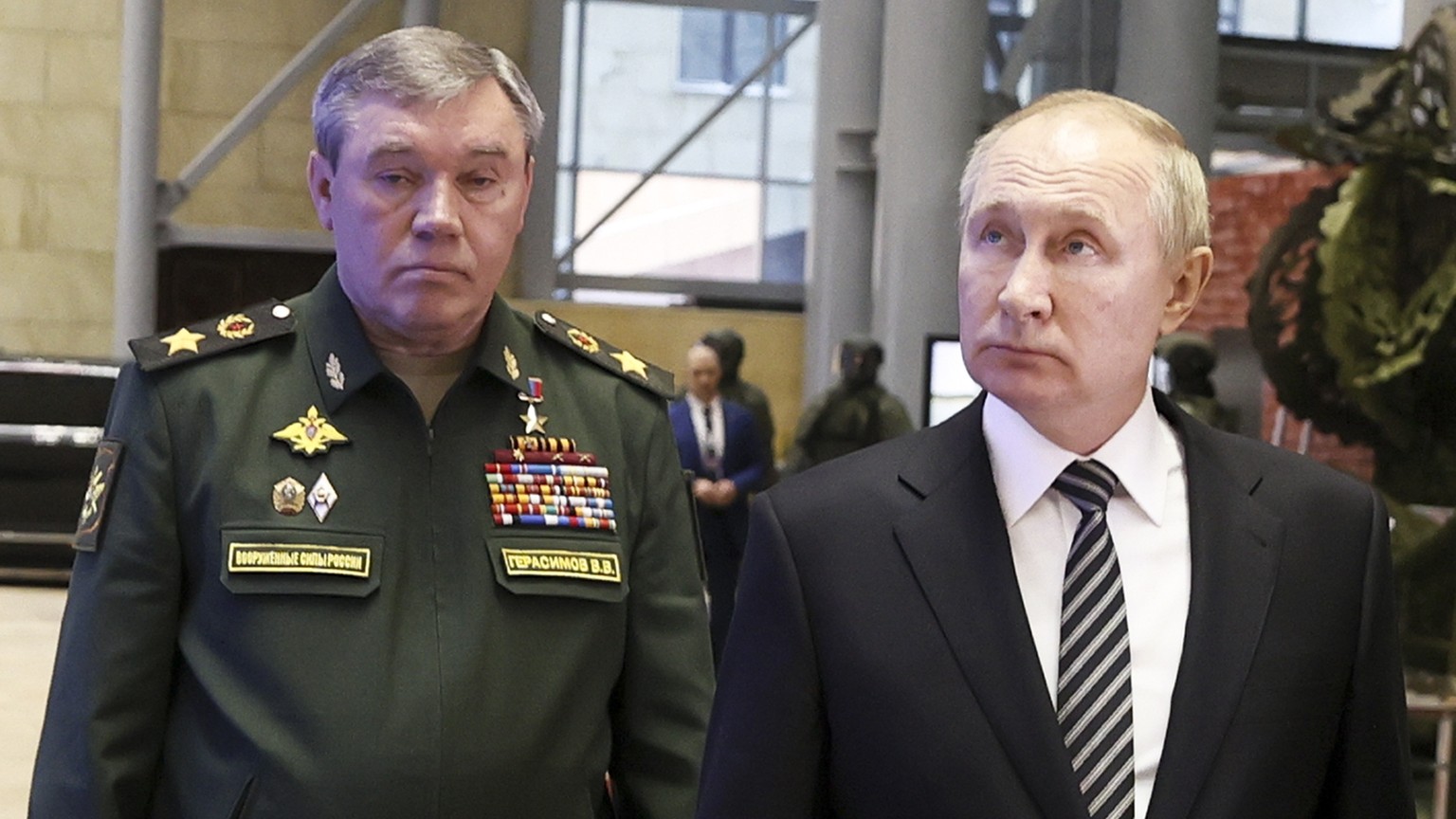 Russian President Vladimir Putin, center, escorted by Russian Defense Minister Sergei Shoigu, right, and General Staff Valery Gerasimov walk after attending an extended meeting of the Russian Defense  ...