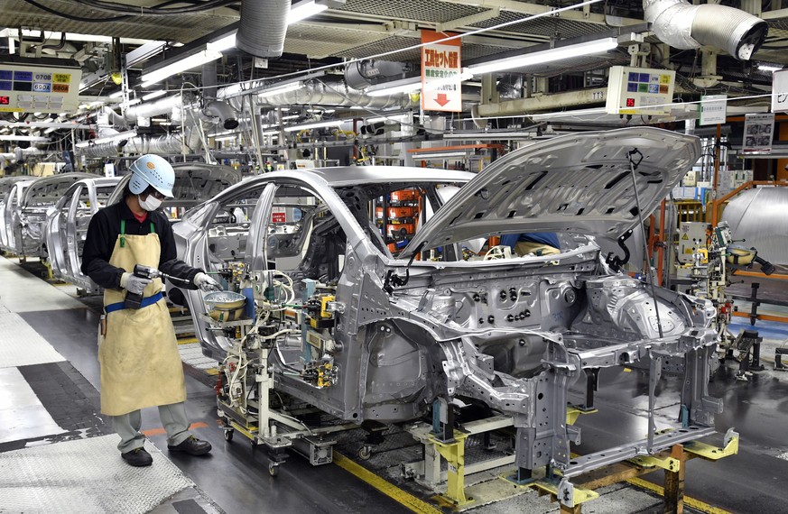 epa09792874 (FILE) - Workers assemble vehicles at the Toyota Tsutsumi car assembly plant in Toyota, near Nagoya, central Japan, 08 December 2017 (reissued 01 March 2022). On 01 March 2022, Toyota Moto ...