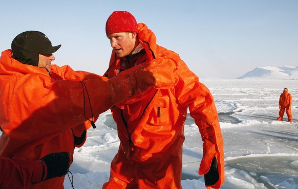 Britain&#039;s Prince Harry is helped as he takes off his immersion suit, during training for the Walking with the Wounded expedition, on the island of Spitsbergen, situated between the Norwegian main ...