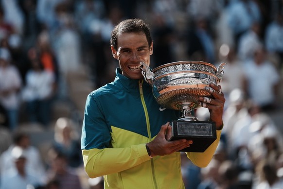 Spain&#039;s Rafael Nadal bites the cup after defeating Norway&#039;s Casper Ruud in their final match of the French Open tennis tournament at the Roland Garros stadium Sunday, June 5, 2022 in Paris.  ...