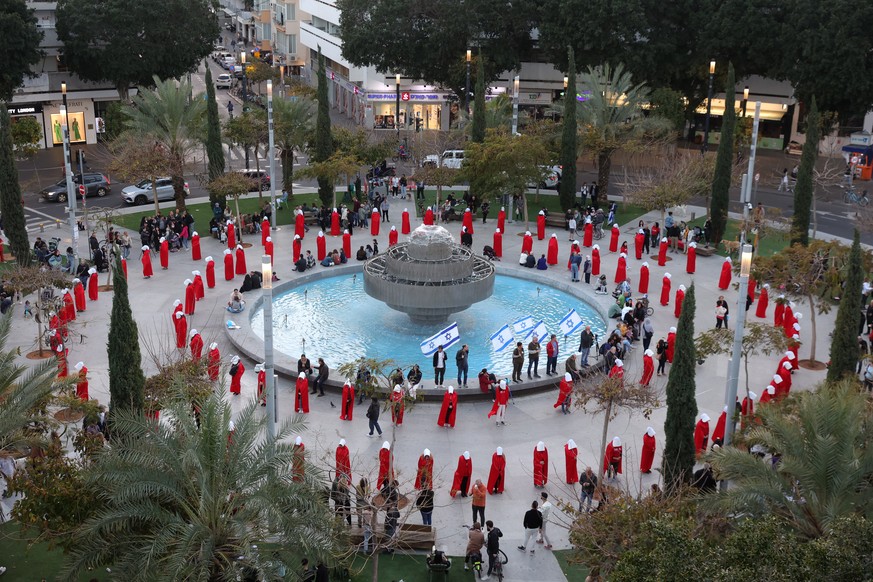 epa10490535 Women protesters wearing &#039;Handmaid&#039;s Tale&#039; costumes demonstrate near the Dizengoff Square ahead of a mass protest against the government justice system reform plan in Tel Av ...