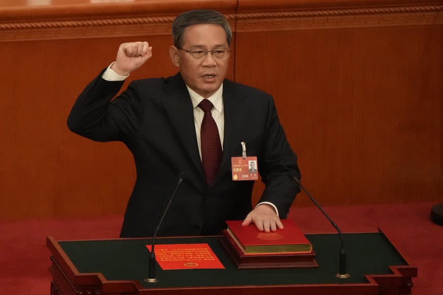 Newly elected Chinese Premier Li Qiang takes his oath during a session of China&#039;s National People&#039;s Congress (NPC) at the Great Hall of the People in Beijing, Saturday, March 11, 2023. (AP P ...