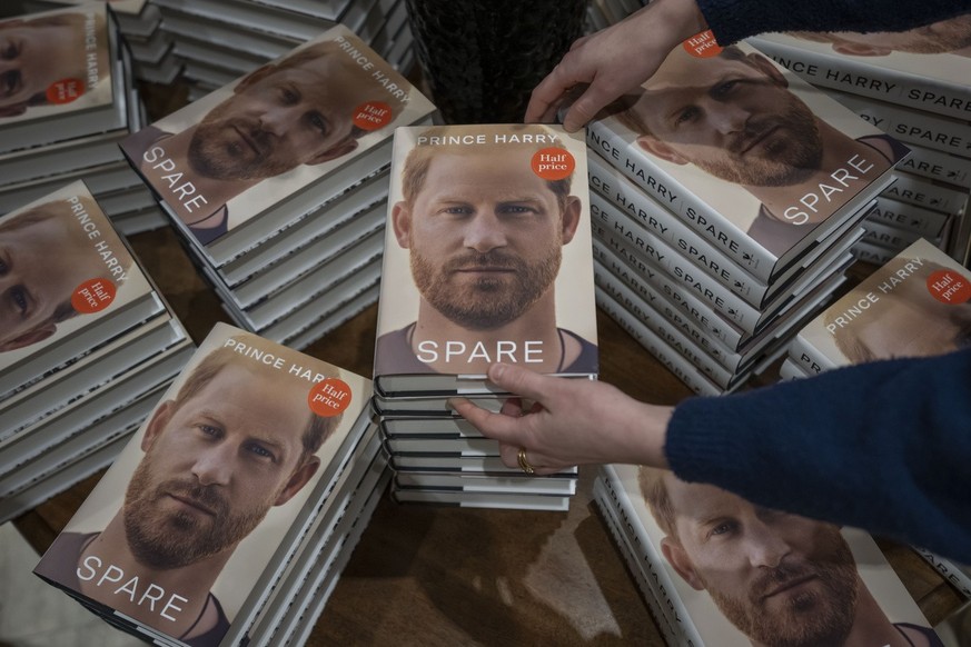 A member of staff places the copies of the new book by Prince Harry called &quot;Spare&quot; at a book store in London, Tuesday, Jan. 10, 2023. Prince Harry&#039;s memoir &quot;Spare&quot; went on sal ...