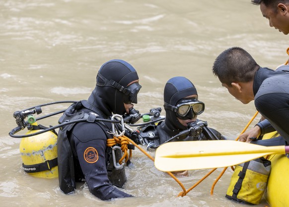 epa11475482 Members of a rescue team conduct a search and rescue operation after two passenger buses were swept away by a landslide, at Trishuli River in Simaltal, Chitwan district, Nepal, 13 July 202 ...